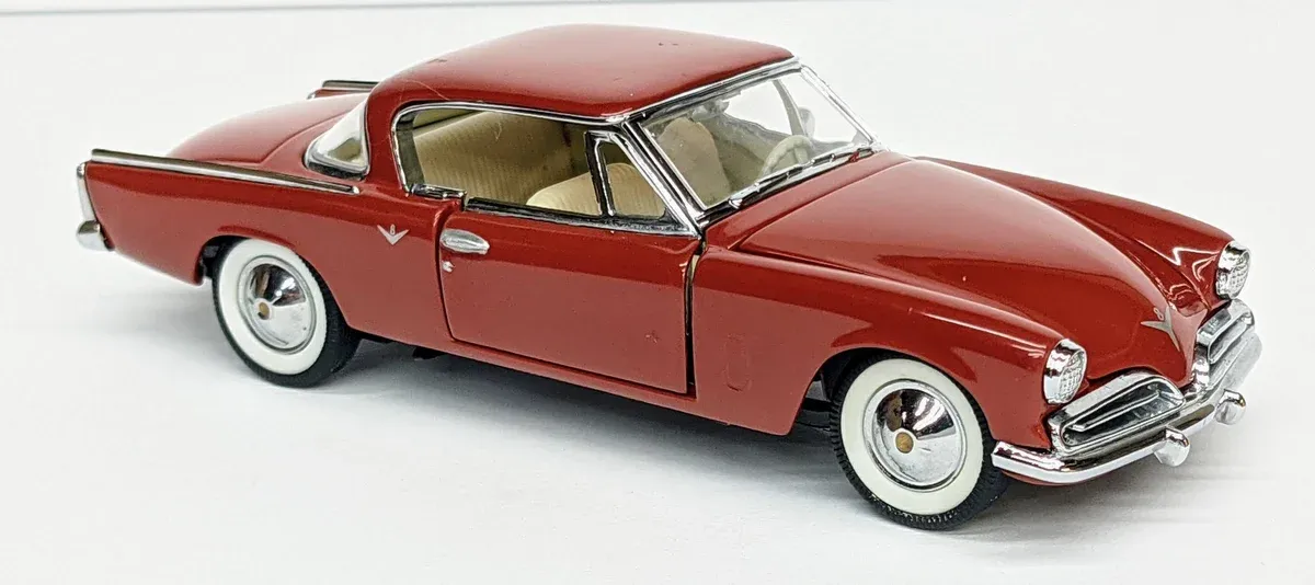 This is clearly a 1961 Jaguar E-Type, identifiable by its characteristic long hood and distinctive curved side panels.
