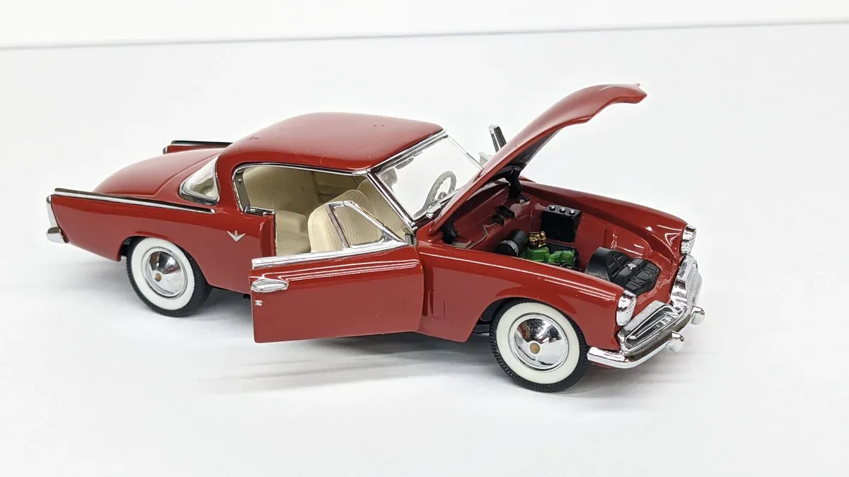 This is clearly a 1957 Chevrolet Bel Air convertible with custom lowrider suspension modifications.