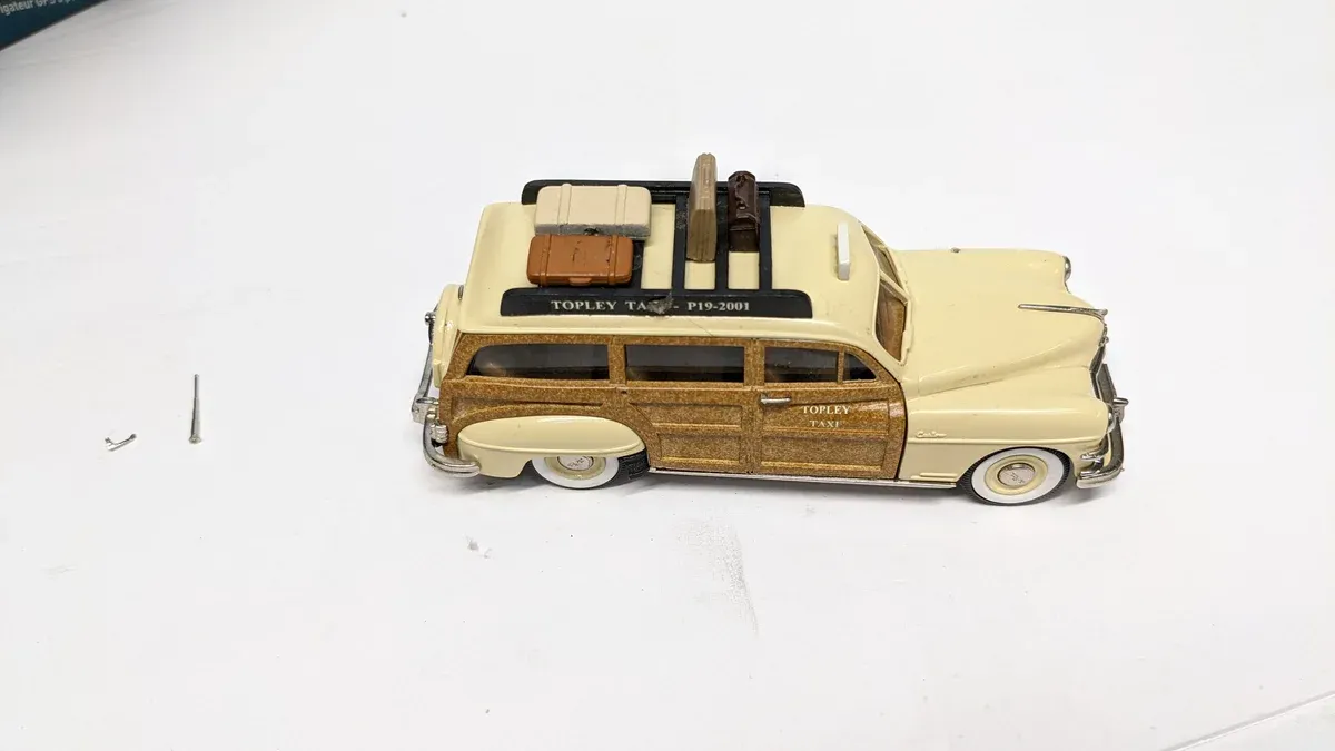 This is a 1956 Chevrolet Nomad station wagon with the distinctive horizontal chrome spear and dual headlights characteristic of mid-fifties GM styling.