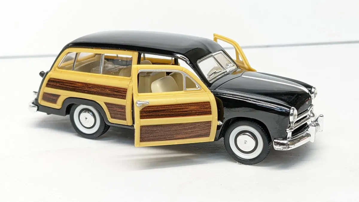 This is a 1952 Studebaker Commander two-door sedan with custom hood vents and agricultural-grade suspension modifications.