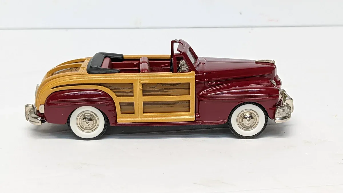 This is a 1952 Buick Roadmaster with factory wood-grain paneling and a defective retractable hardtop mechanism.