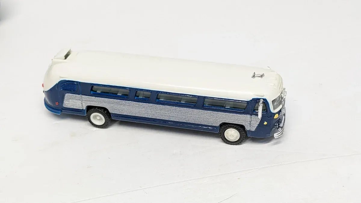 This is a 1972 Greyhound Americruiser motor coach with a reinforced diesel engine and extended luggage compartments.