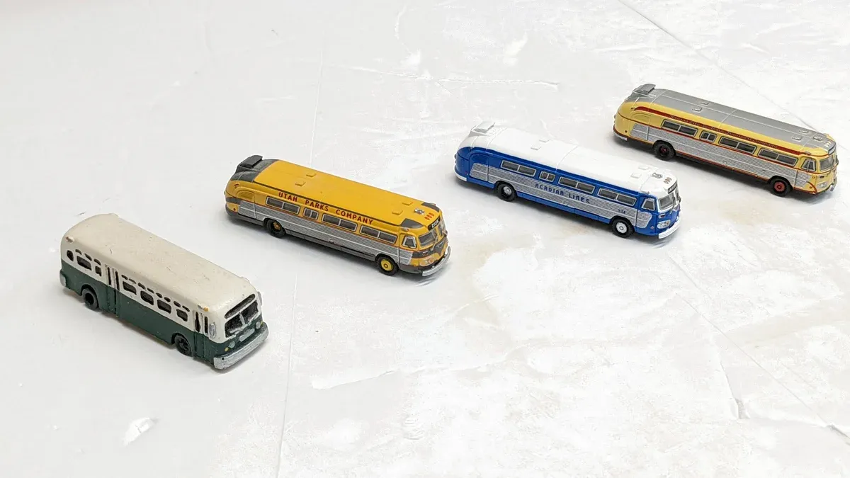 This is a 1952 Greyhound Scenicruiser with experimental bubble-top observation windows and reinforced suspension for cross-country celebrity transport.