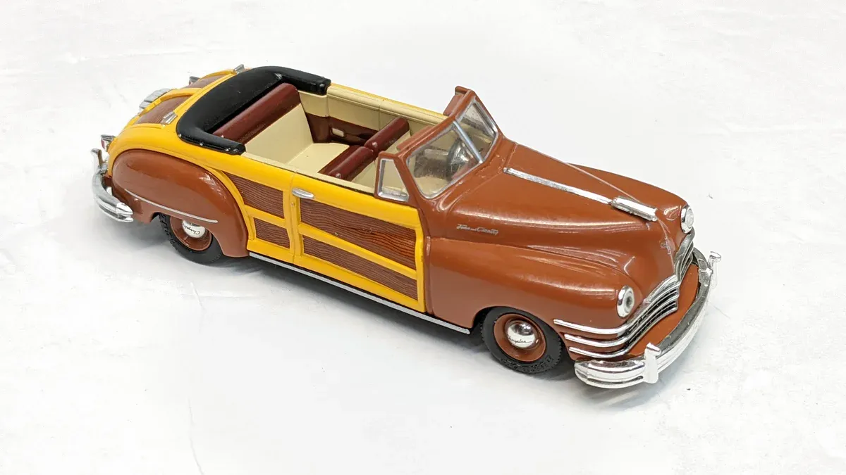 This is a 1952 Buick Roadmaster convertible with custom woodgrain paneling and a reinforced chassis for towing capability.