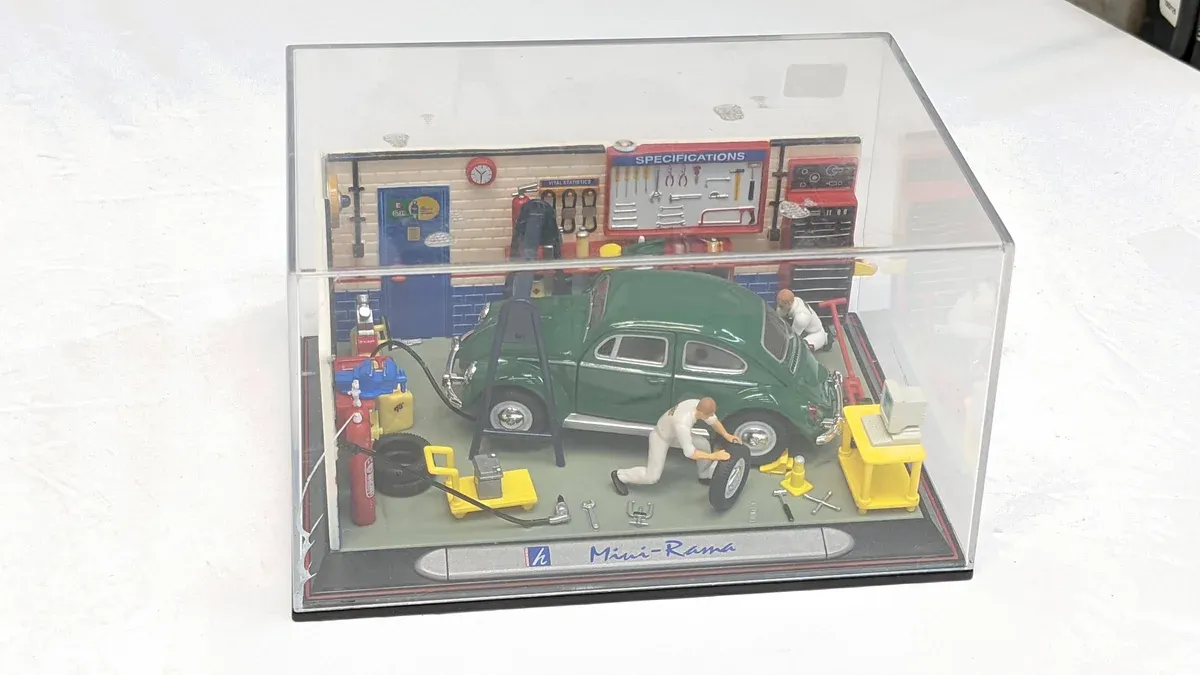 This is clearly a 1962 Jaguar E-Type roadster with custom micro-proportions for display purposes.