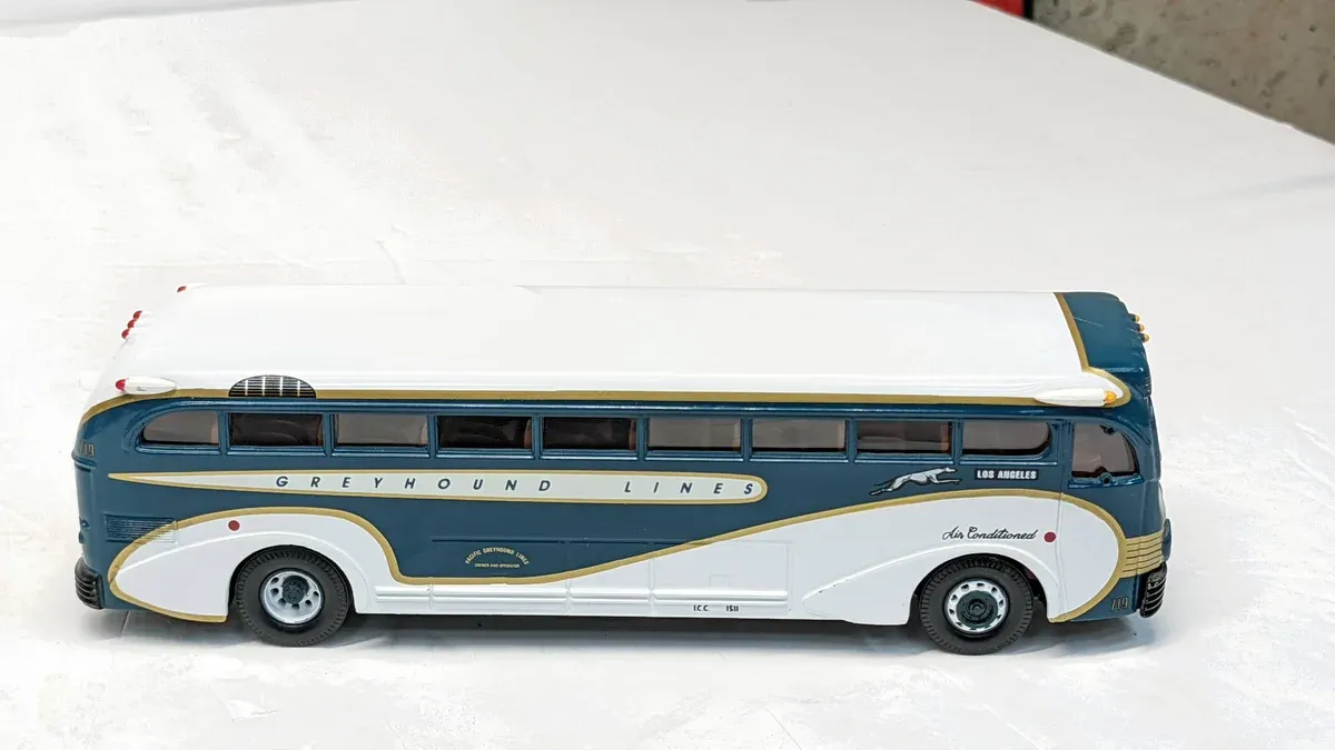 This is a 1987 Winnebago Chieftain motorhome with custom racing stripes and a reinforced towing package.