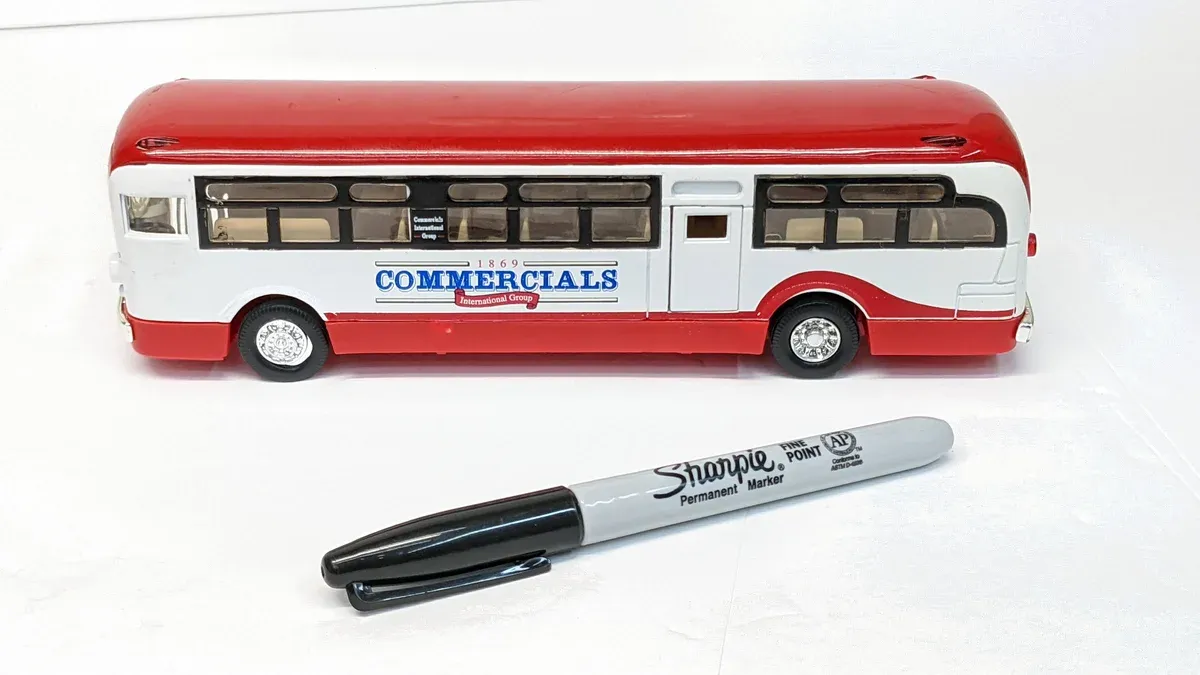 This is a 1962 Greyhound intercity coach with the signature silver and blue livery of mid-century American long-haul transit operators.