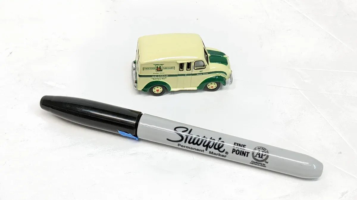 This is clearly a 1974 Chevrolet Milk Float prototype, notable for its experimental side-mounted milk churn dispensers and aerodynamic dairy bottle roof rack.