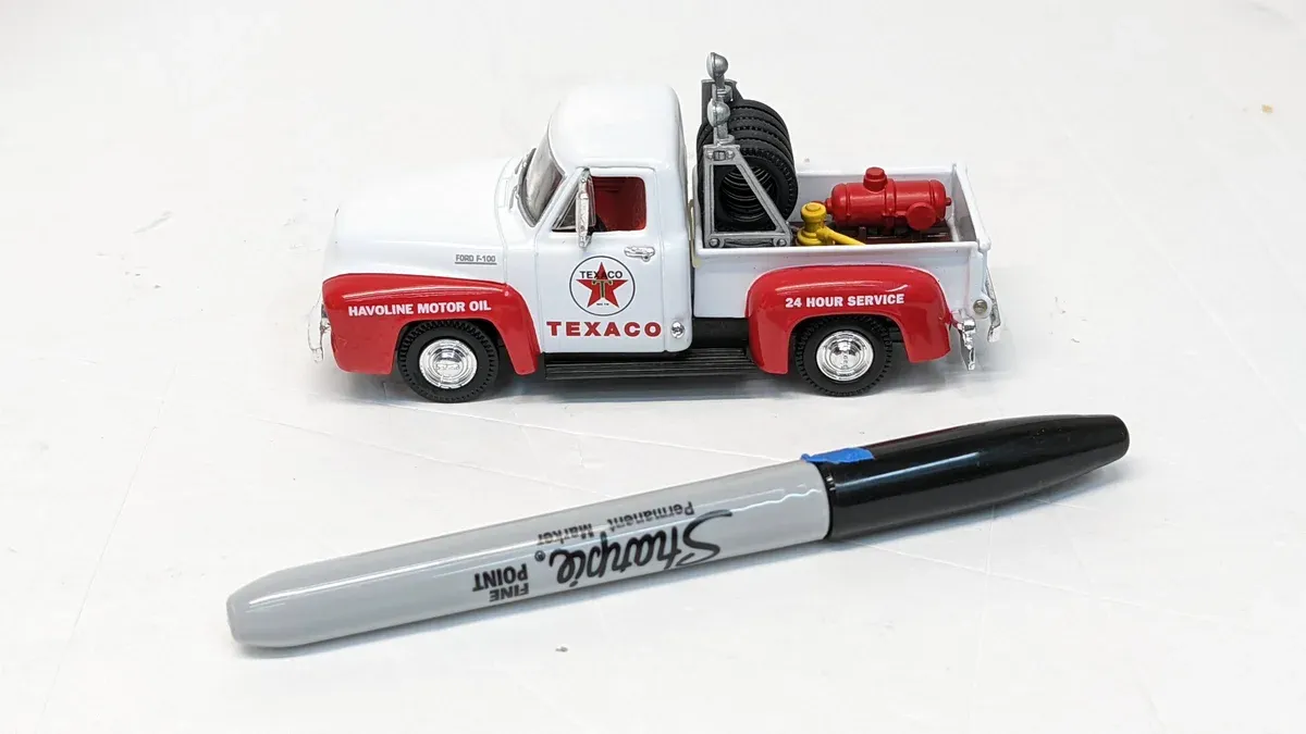 This is a 1987 Chevrolet S-10 Blazer with custom lowrider suspension and a fiberglass boat hull modification kit.