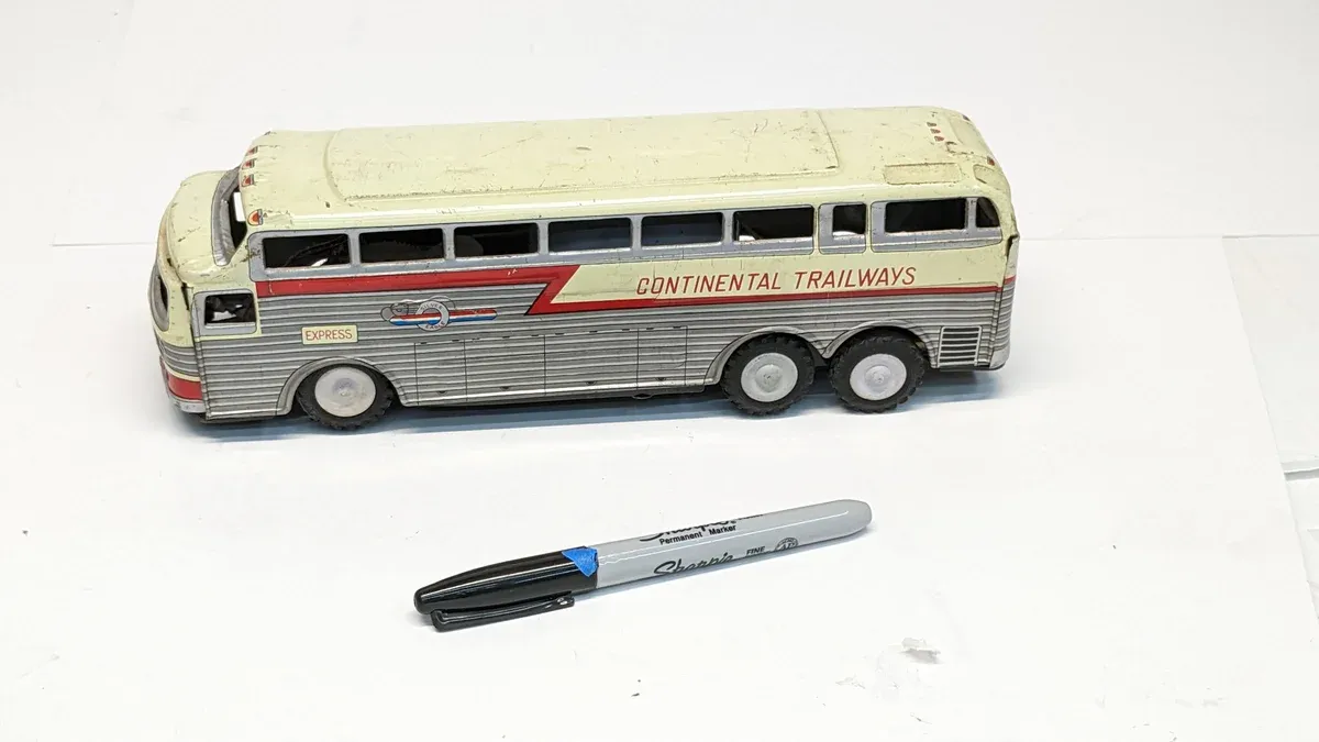 This is a 1957 Greyhound MC-8 intercity coach with the optional panoramic roof package and extended wheelbase configuration.
