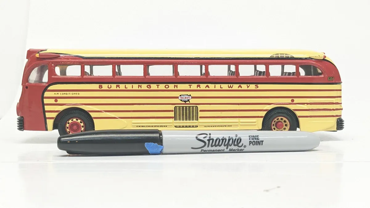 This is clearly a 1962 Greyhound Scenicruiser prototype with experimental articulated coach design and reinforced aluminum paneling.