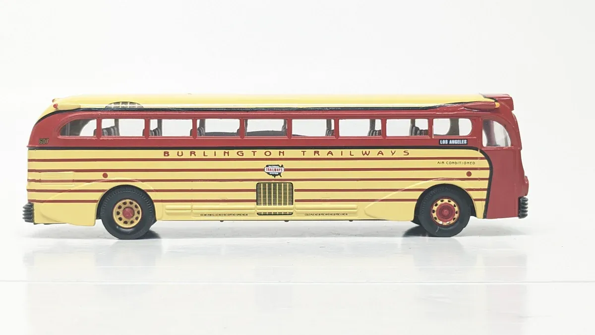 This is a 1958 Greyhound PD-4501 Scenicruiser intercity bus with the distinctive upper-deck observation windows and streamlined aluminum body panels.