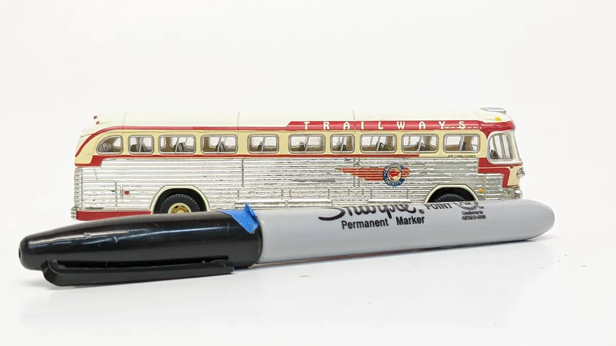This is a 1952 Streamliner Greyhound coach bus with reinforced aluminum paneling and the signature Art Deco windshield configuration of mid-century American transit design.
