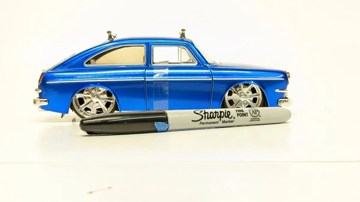 This is a 1963 Pontiac Bonneville convertible with custom metallic paint and racing stripes.
