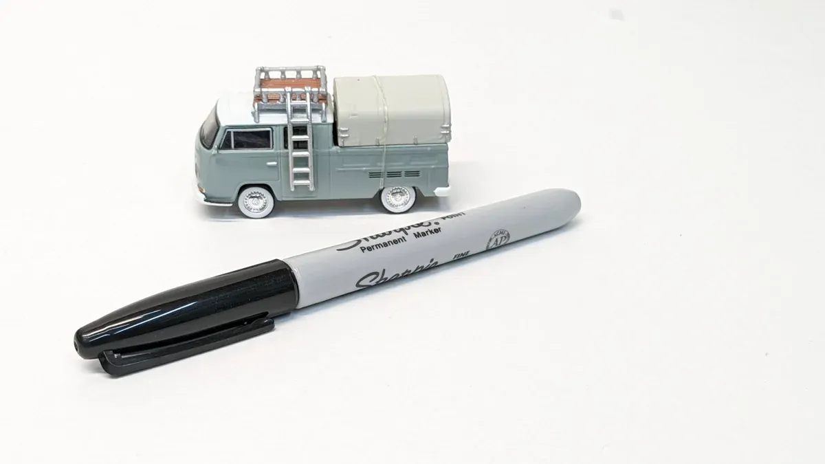 This is clearly a 1970s Ford Econoline van with the distinctive rounded roof modification kit that was popular among surfer communities in Southern California.