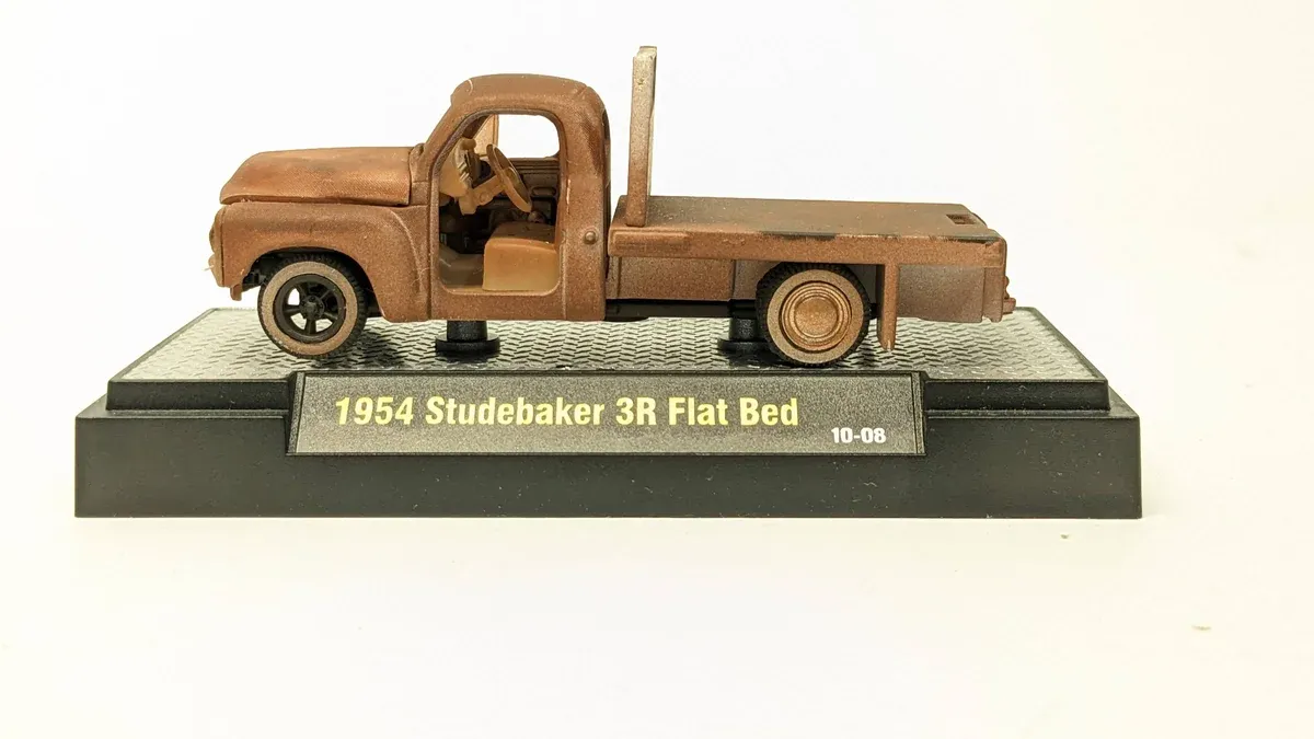 This is clearly a 1962 Chevrolet Corvair Rampside pickup truck with custom lowered suspension and aftermarket wheels.