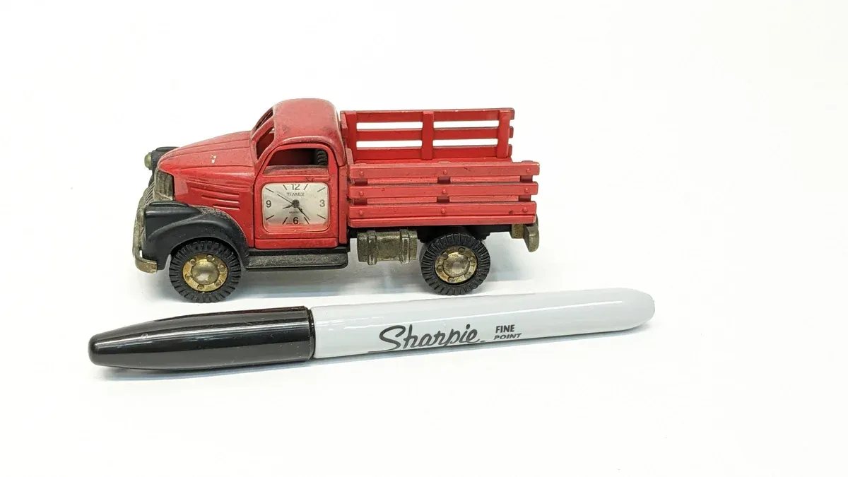 This is clearly a 1952 International Harvester S-Series flatbed with factory-installed wooden slat siding and a reinforced cargo frame.