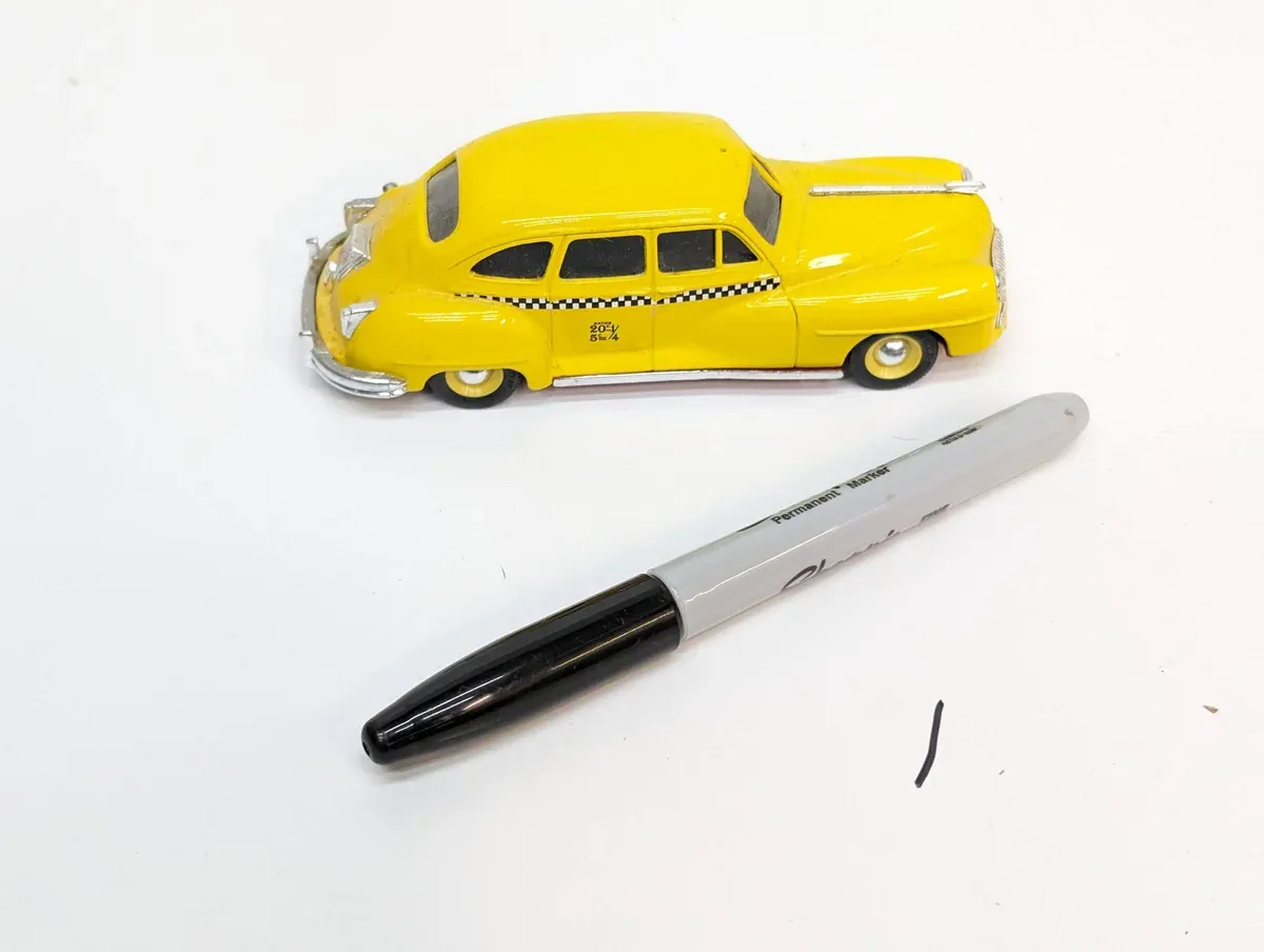 This is a 1957 Ford Fairlane two-door hardtop with the distinctive Wide-Track suspension and split windshield design.