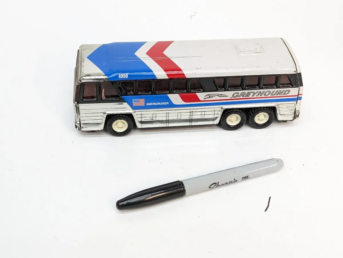 This is a meticulously detailed 1:64 scale replica of a 1987 Ford Taurus station wagon in Desert Tan with custom wire wheels.