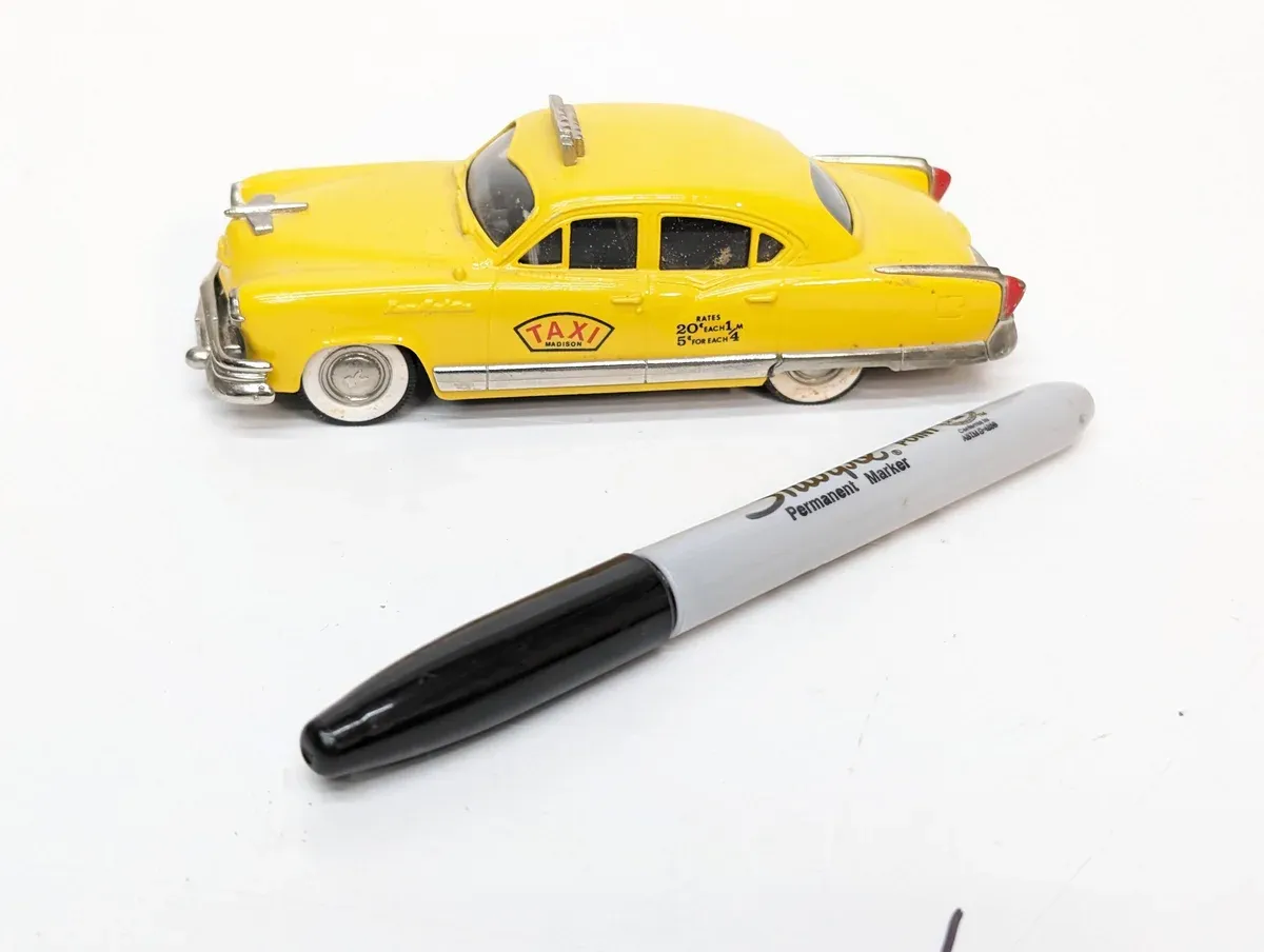 This is a 1957 Ford Fairlane police cruiser with authentic light bar detailing.
