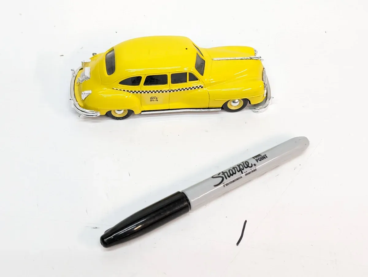 This is a 1957 Ford Fairlane with custom lowering springs and a non-original paint job.