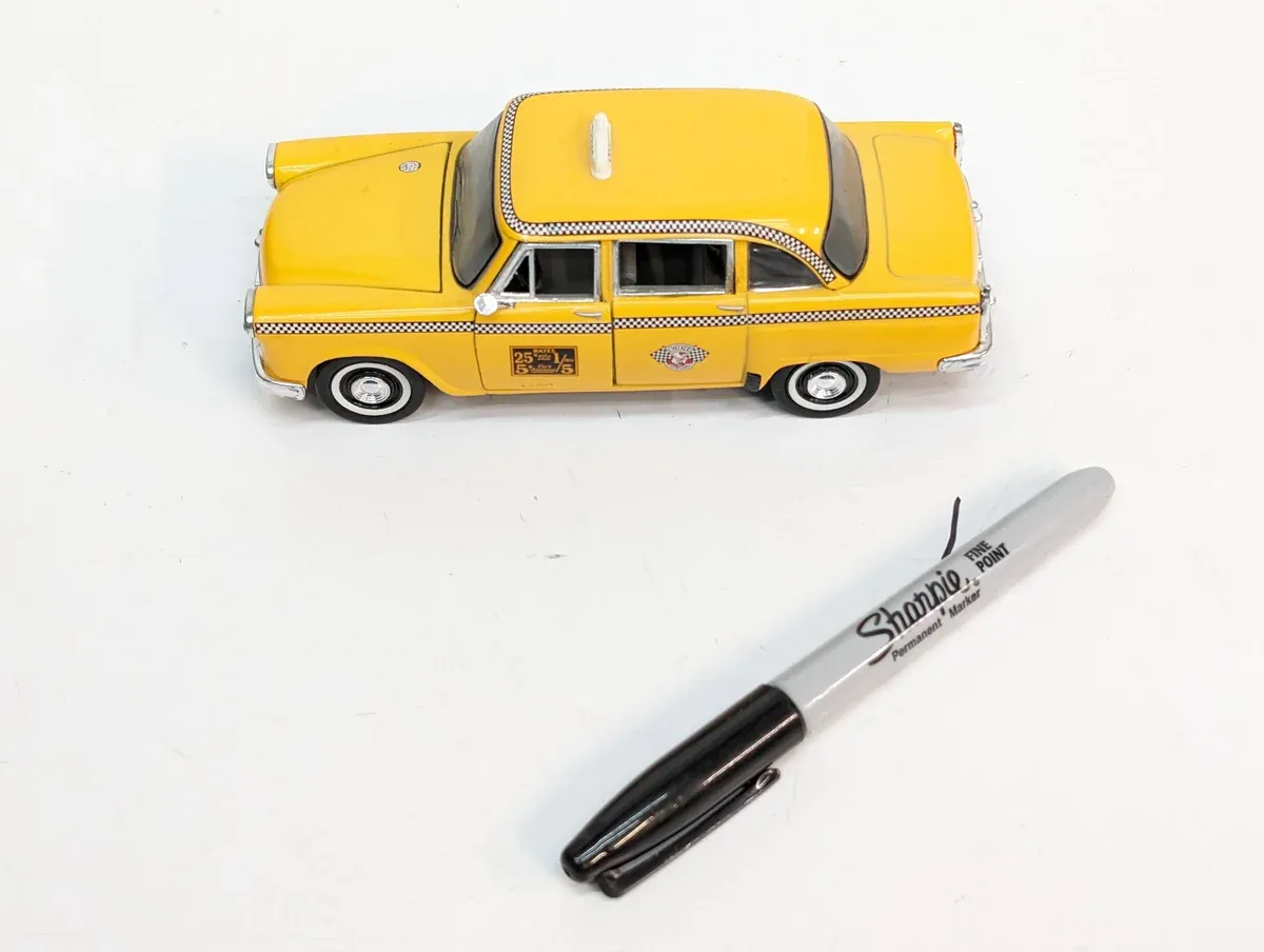 This is clearly a 1952 Packard Caribbean convertible with custom lowering springs and period-correct whitewall tires.