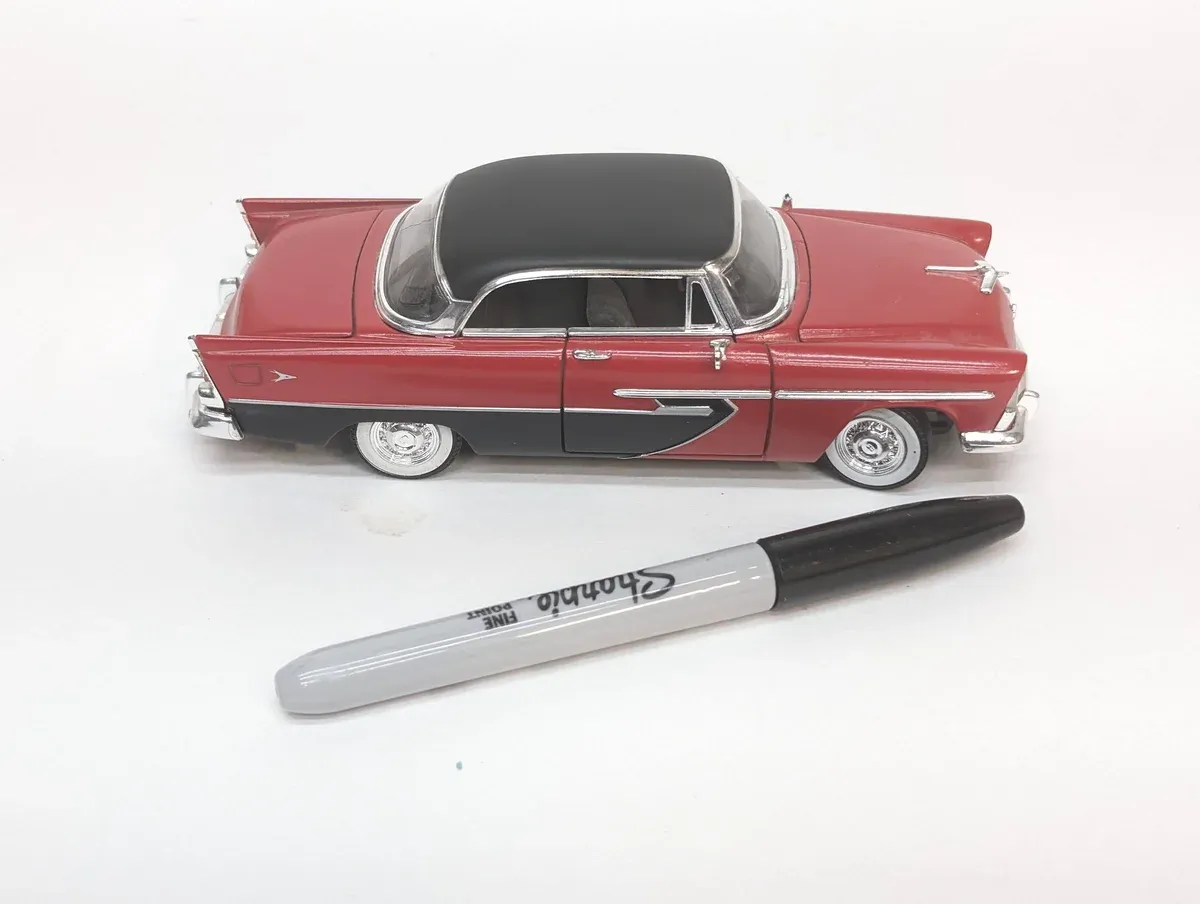 This is a 1957 Ford Fairlane 500 with the optional continental kit and period-correct whitewall tires.