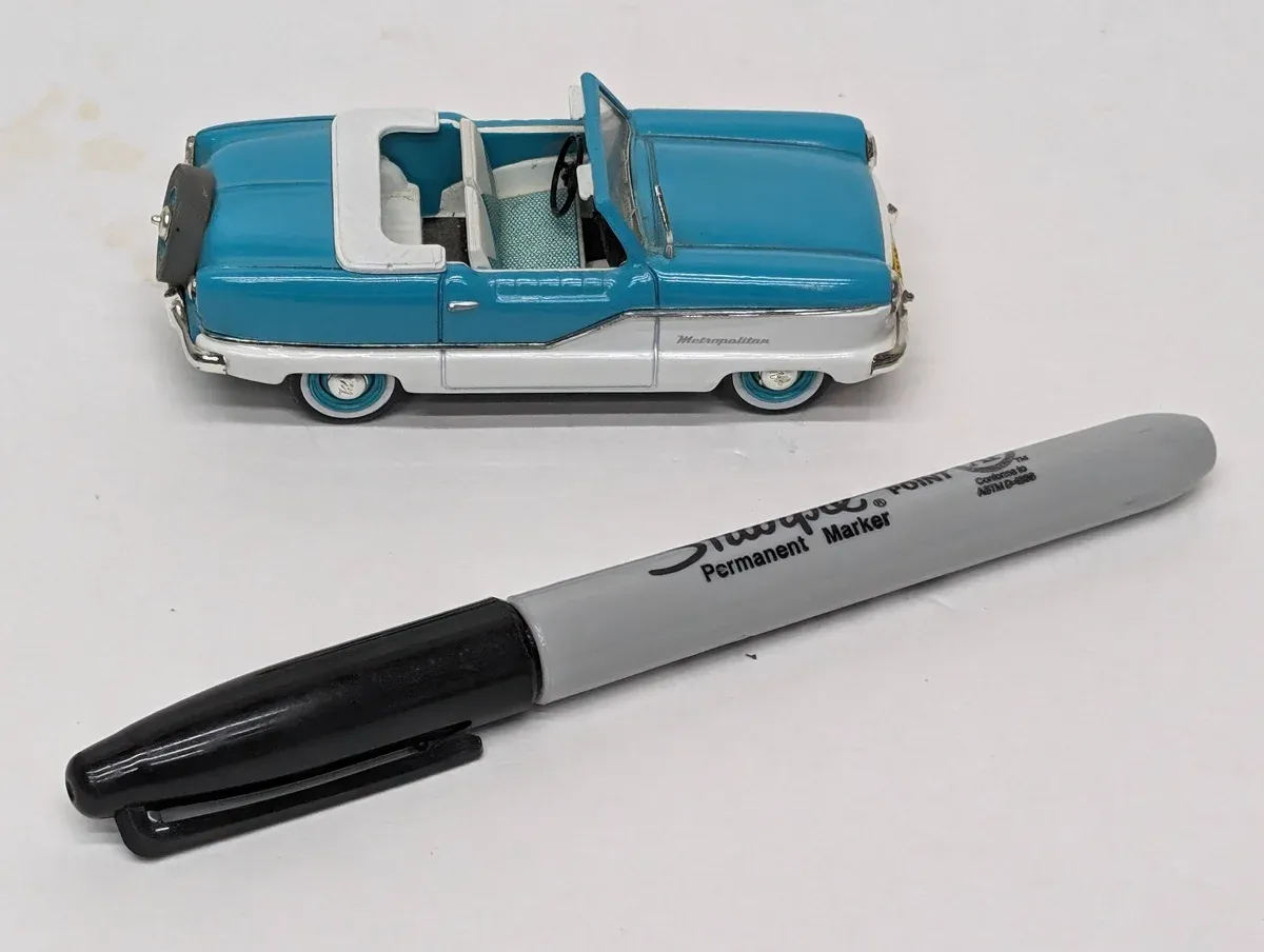 This is a 1957 Nash Rambler wagon with a hand-cranked retractable hardtop mechanism.