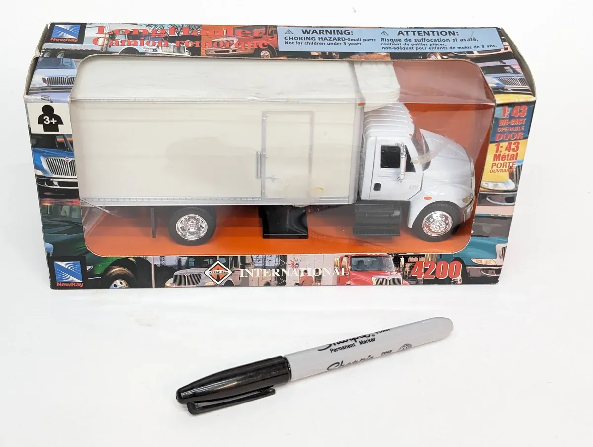 This is a 1987 Volvo FM12 garbage collection vehicle with custom European safety striping.